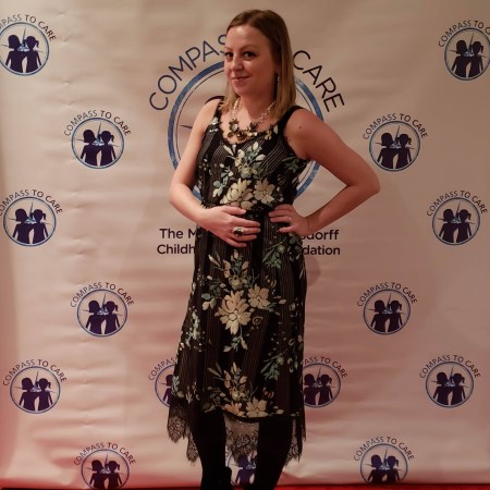 compass to care fashion show red carpet step and repeat