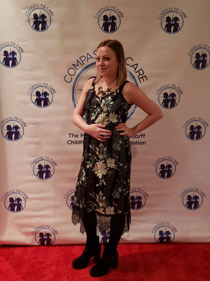 compass to care fashion show red carpet step and repeat